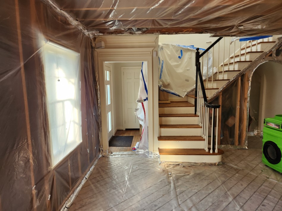 Alternate view of staircase and flooring in process of Winder, GA basement remodeling.